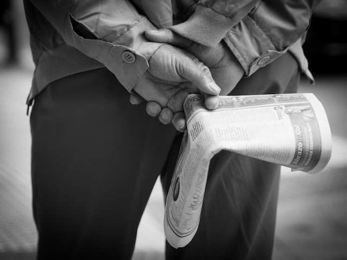 holding newspaper_HERO