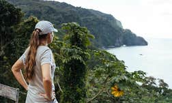 A photo of Dona Bertarelli looking out over the water from the shore.