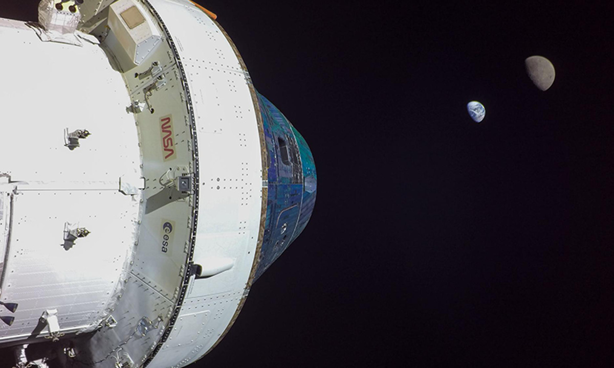 A photo of Artemis I Flight Day 13: Orion, Earth, and moon